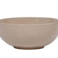 The Juliska Puro Taupe Dinnerware Collection features a round, beige ceramic bowl with smooth sides and a slightly raised base in a versatile taupe hue, ideal for stylish table settings. Shown against a white background.