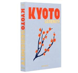 Immerse yourself in Japanese culture with Assouline's "Kyoto Serenity," a beautifully illustrated book featuring a simple floral branch on its cover. Discover the harmonious world of Kyoto, capturing the vibrant spirit of Gion Matsuri.