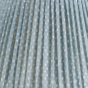 Close-up of the Fermoie Blue Figured Lampshade by John Rosselli, showcasing light blue pleated fabric with a subtle white dotted pattern and visible woven texture.
