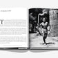 Open book displaying a page with the heading "INTRODUCTION" on the left and a black-and-white photo of a shirtless man carrying a torch from the Summer Olympics history on the right, featured in "The Last Heroes: 100 Moments of Olympics Legend" by Assouline.