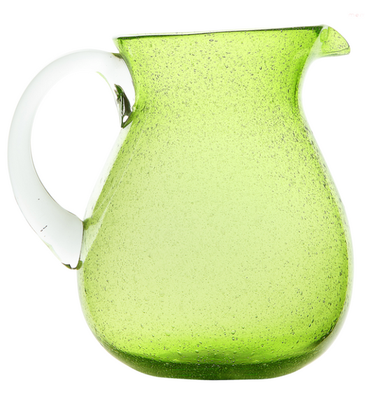 A translucent green Memento Acrylic Pitcher Collection, showcasing unique colors, with condensation droplets on its surface, isolated on a white background.