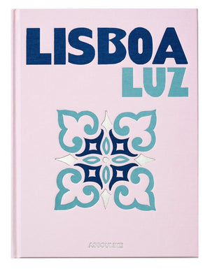 The "Lisboa Luz" book by Assouline features a geometric tile design in blue and teal on a light pink cover, capturing the unique charm and vibrant spirit of Lisbon.