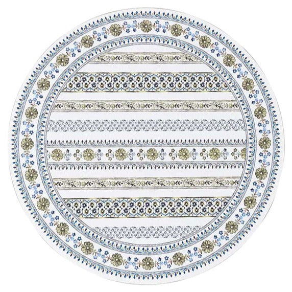 The Juliska Seville Placemat features an oval shape and a vibrant decorative pattern of alternating floral motifs and geometric stripes in blue, green, and beige, inspired by the designs of Seville.