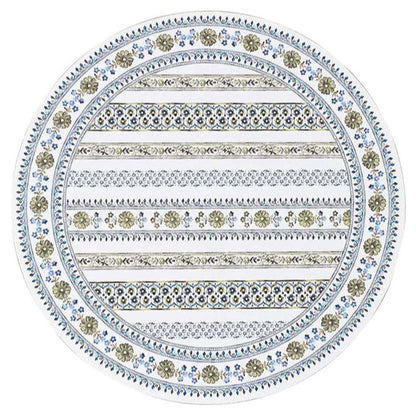The Juliska Seville Placemat features an oval shape and a vibrant decorative pattern of alternating floral motifs and geometric stripes in blue, green, and beige, inspired by the designs of Seville.