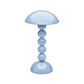 The Addison Ross Bobbin LED Cordless Lamp is a glossy light blue lamp with adjustable lighting, featuring a dome-shaped shade and a base of four stacked spheres, shown against a white background.