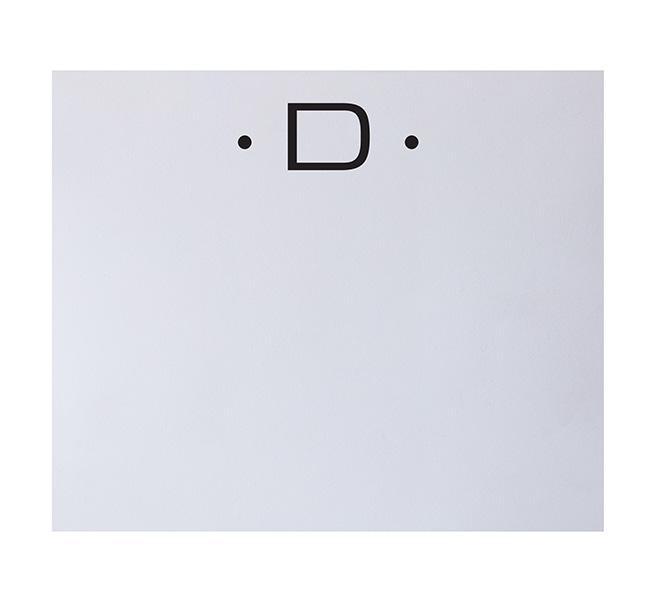 The Black Ink Black Initial Large Notepad features a white background with a simple emoticon—two black dots and a capital letter D—that resembles a smiling face, perfect for fine stationery crafted from luxurious paper.
