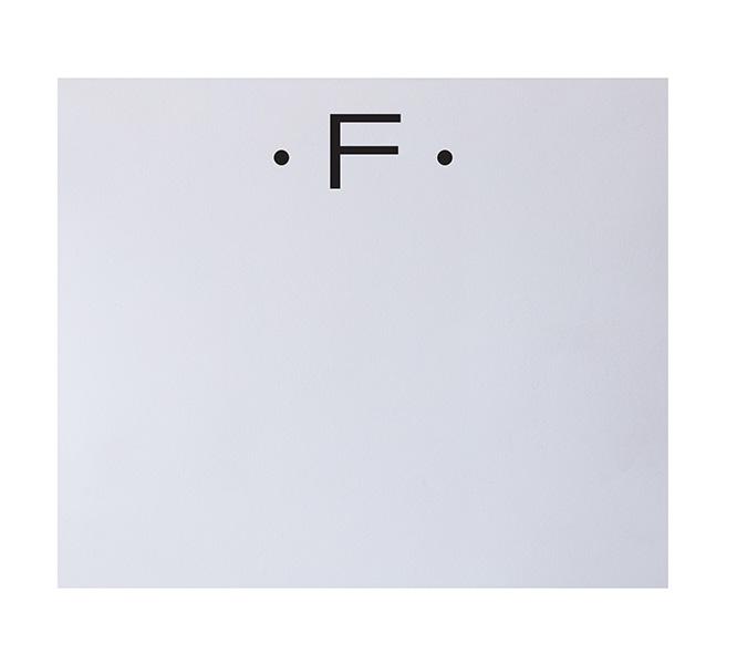 The Black Ink Black Initial Large Notepad features a white background with a bold black "F" at the top, flanked by dots—an elegant design inspired by fine stationery and luxurious quality paper.