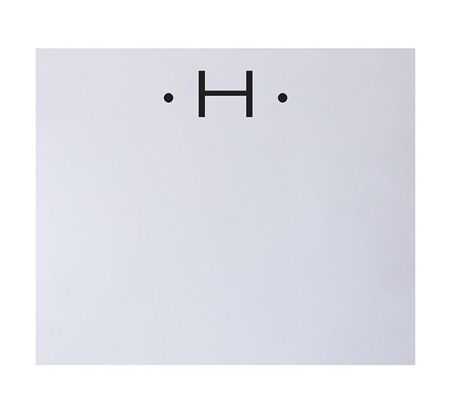 The Black Ink Black Initial Large Notepad features a bold uppercase "H" centered atop a white background, accented by single dots on each side—a sophisticated design perfect for fine stationery or any luxury-quality notepad.