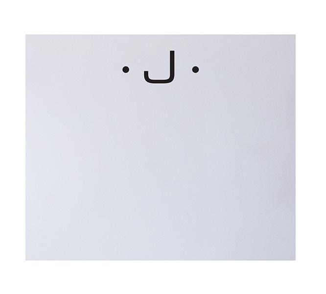 The Black Initial Large Notepad by Black Ink features a minimalist smiling face with two black dots and a curved line on a luxe pad, offering fine stationery style and luxurious quality paper.