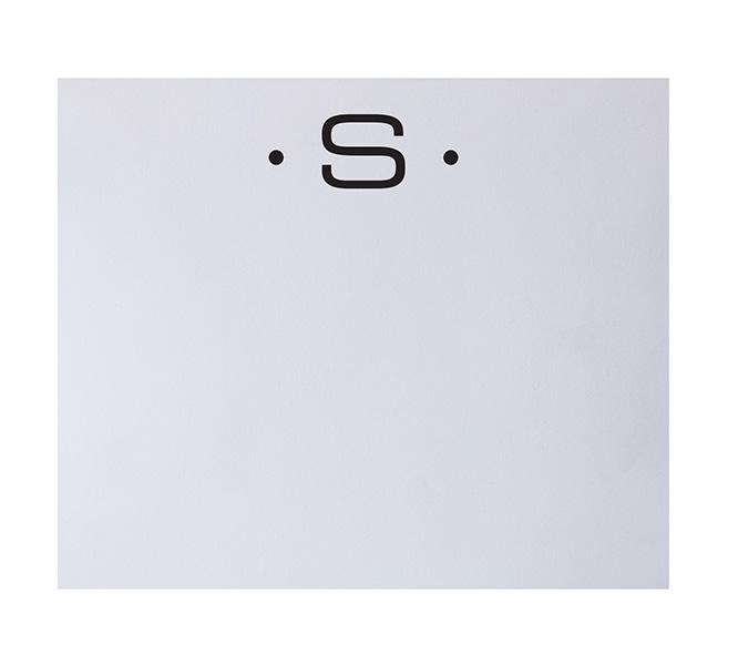 The Black Initial Large Notepad by Black Ink features a bold black "S" centered near the top on a white background, flanked by small black dots, combining elegant stationery design with the luxurious appeal of quality paper.