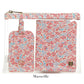 A clear zippered pouch showcases a floral LUXE Saffiano Travel Set by TRVL Design, featuring a matching luggage tag and passport cover in pink, blue, and white. "Marseille" appears below.