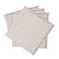 The Laksha Napkin Set by Matouk features four beige cloth napkins adorned with a delicate brown geometric pattern, reminiscent of block printing, artfully fanned out against a plain white background.