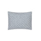 A rectangular pillow from the Laksha Bedding Collection by Matouk, featuring a white percale cover with a repeating blue geometric dot pattern inspired by Indian block printing, displayed against a plain white background.