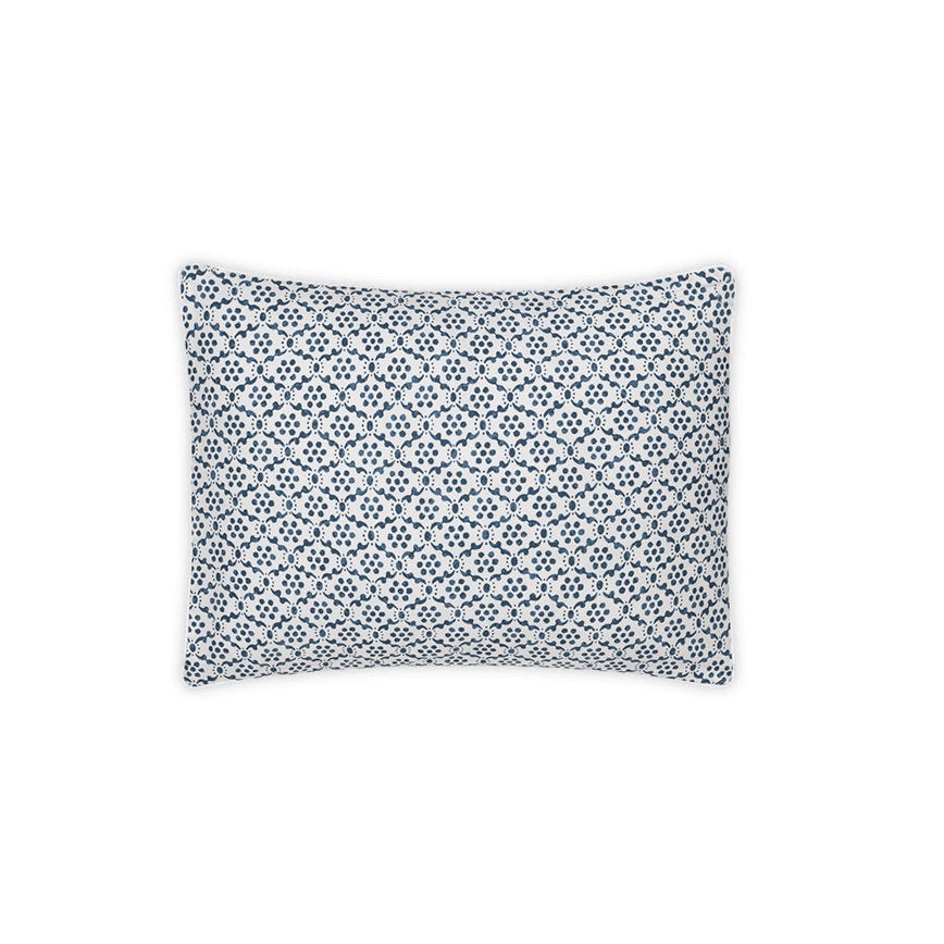 A rectangular pillow from the Laksha Bedding Collection by Matouk, featuring a white percale cover with a repeating blue geometric dot pattern inspired by Indian block printing, displayed against a plain white background.