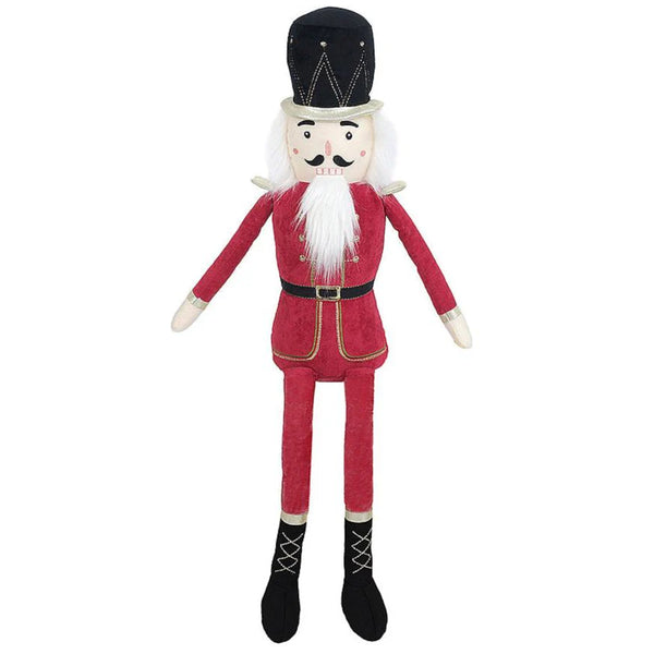 The Mon Ami The Nutcracker Shelf Sitter - Large Red is a plush doll resembling a classic figure. It is made from polyester and features a red uniform, black boots, and a black hat, along with a white beard and mustache. This charming piece from Mon Ami is perfect as holiday decor.