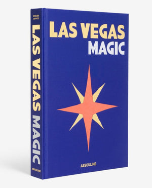 The book "Las Vegas Magic" by Assouline showcases a cover with a red and yellow starburst design set against a blue background, evoking the feel of neon signs lighting up the lively cityscape.