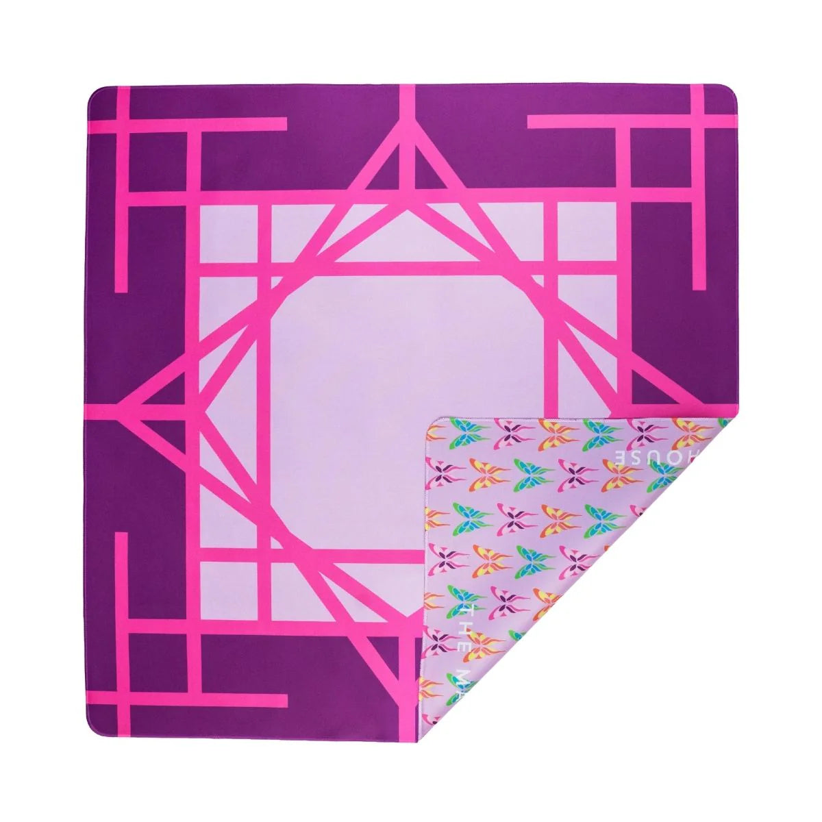 The Mahjong House Double-Sided Travel Mahjong Mat features a geometric pink and purple front and a multicolored leaf design on the reverse, combining style and portability for gameplay anywhere.