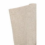 A close-up of the Lina Strie Rug by Magdalena York, a beige woven indoor-outdoor rug, partially rolled up against a white background.
