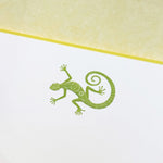 Printery's Lizard Note Cards feature a green, intricately patterned gecko illustration centered on a bone white card with a yellow top border—perfect for anyone who loves unique lizard-themed stationery.