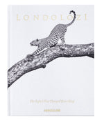 Assouline’s "Londolozi: The Safari that Changed Everything" showcases a black and white illustration of a leopard stretching on a tree branch, evoking the essence of wilderness adventure and conservation.