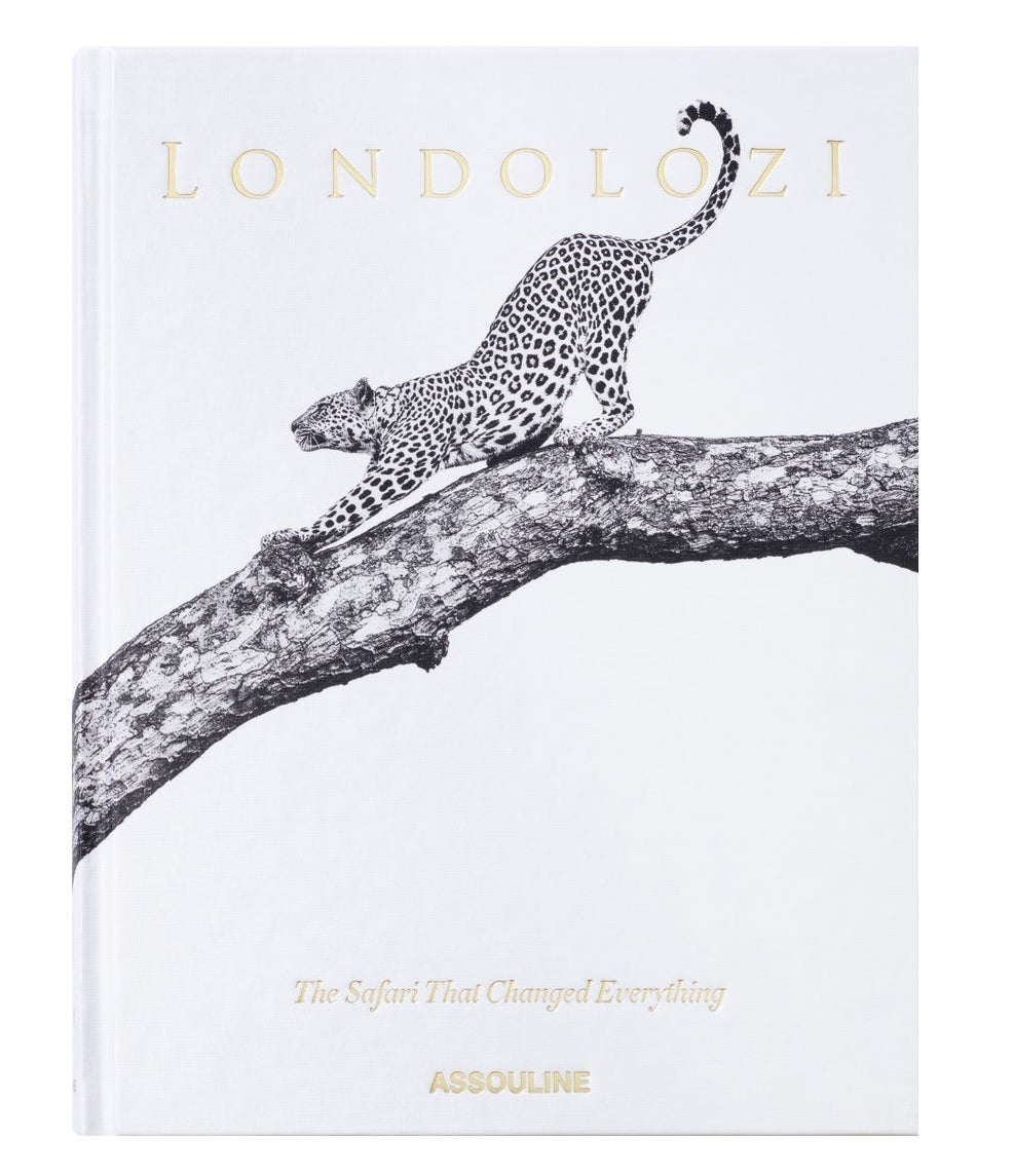 Assouline’s "Londolozi: The Safari that Changed Everything" showcases a black and white illustration of a leopard stretching on a tree branch, evoking the essence of wilderness adventure and conservation.