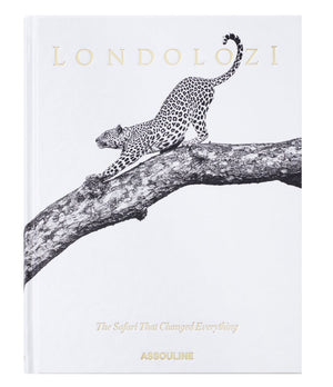 Assouline’s "Londolozi: The Safari that Changed Everything" showcases a black and white illustration of a leopard stretching on a tree branch, evoking the essence of wilderness adventure and conservation.