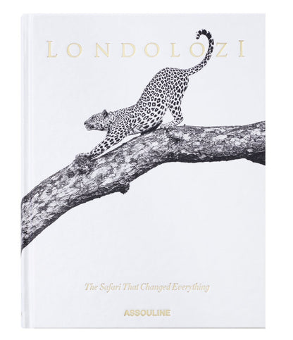 Assouline’s "Londolozi: The Safari that Changed Everything" showcases a black and white illustration of a leopard stretching on a tree branch, evoking the essence of wilderness adventure and conservation.