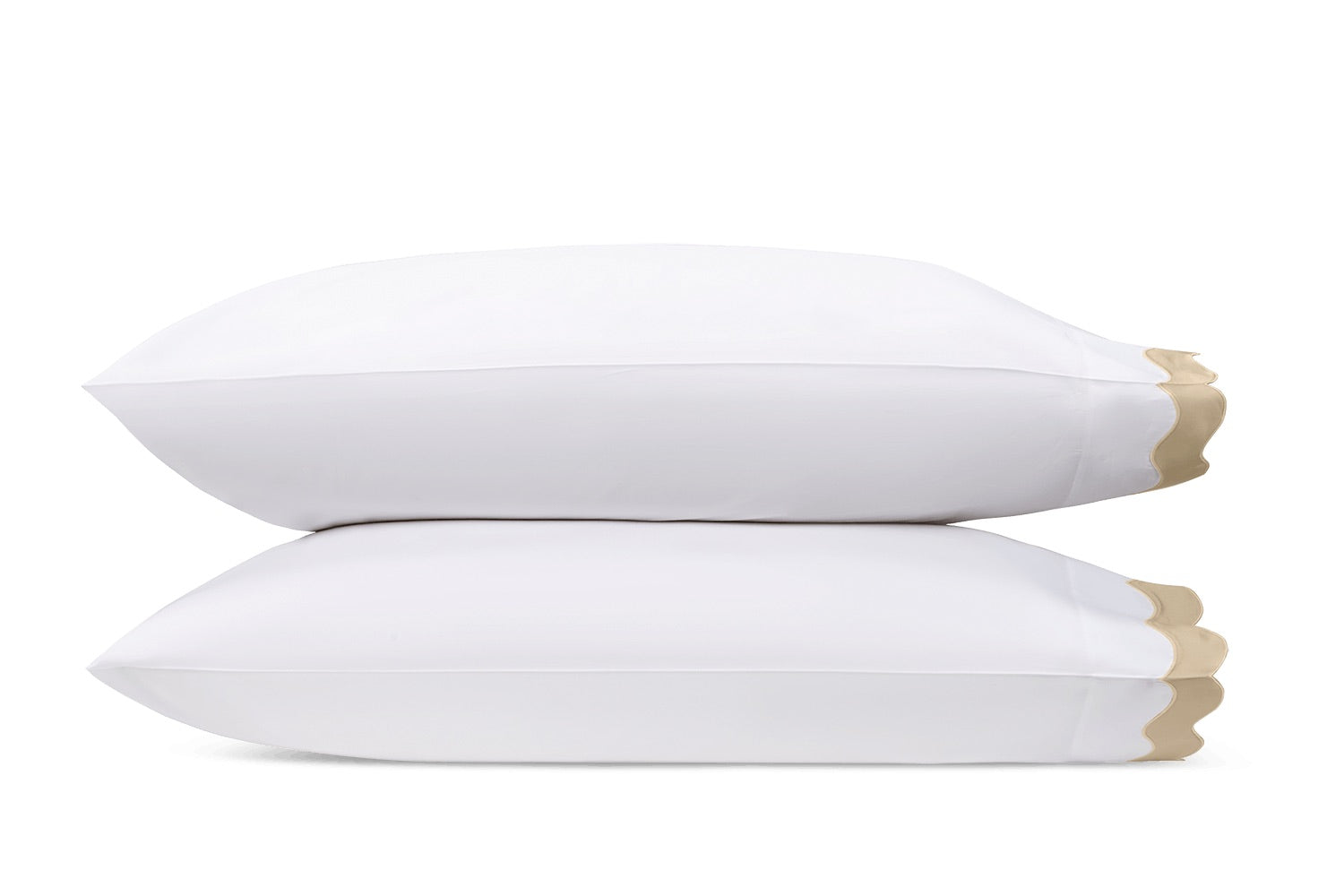 Two white pillows from the Lorelei Bedding Collection by Matouk, featuring beige appliqué scalloped edges and crafted from luxurious 600-thread-count Egyptian cotton, are stacked atop each other against a plain white background.