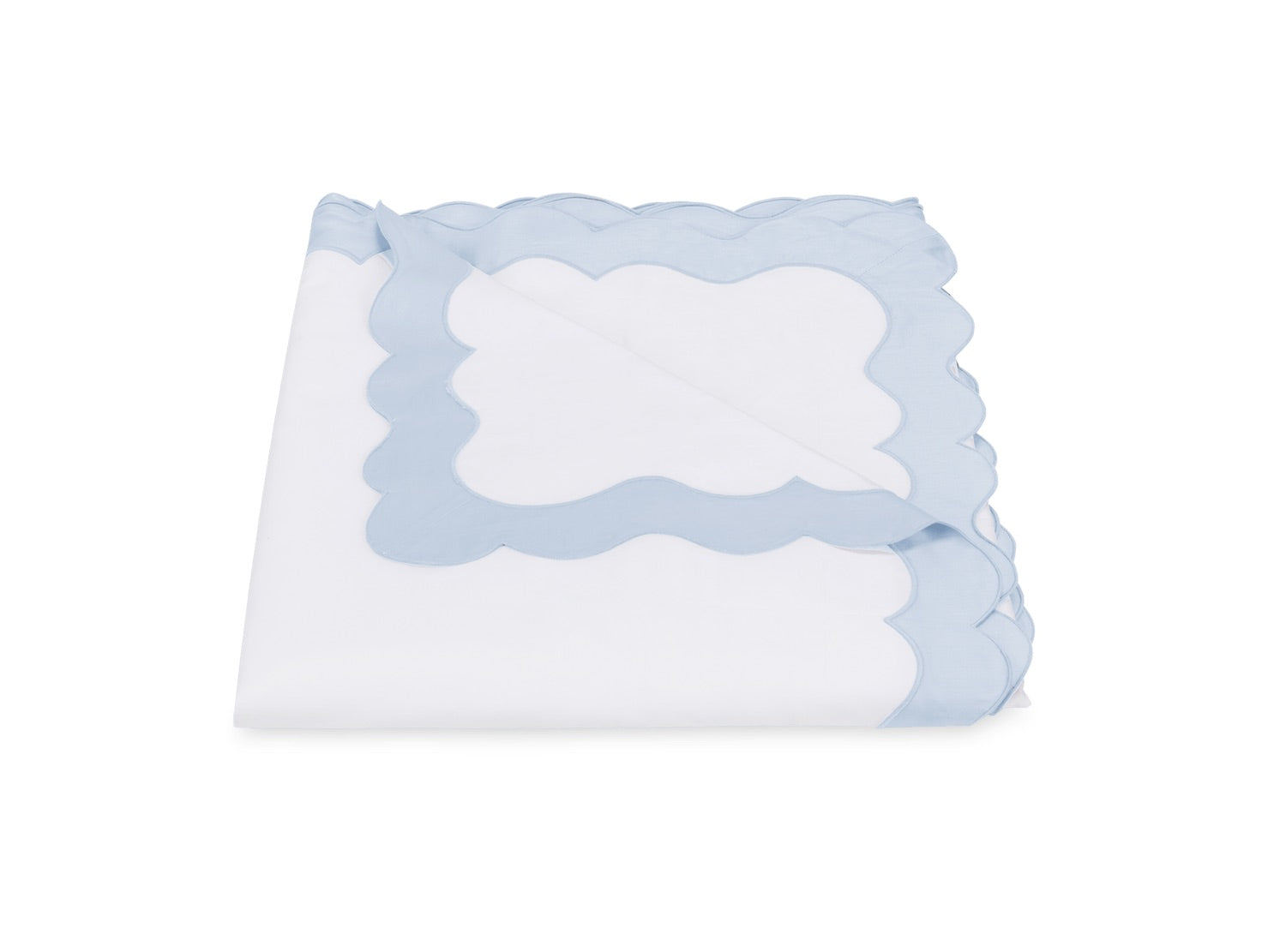 Folded white cloth from the Matouk Lorelei Bedding Collection, featuring light blue appliqué scallop trim and crafted from luxurious 600 thread count Egyptian cotton, displayed on a white background.
