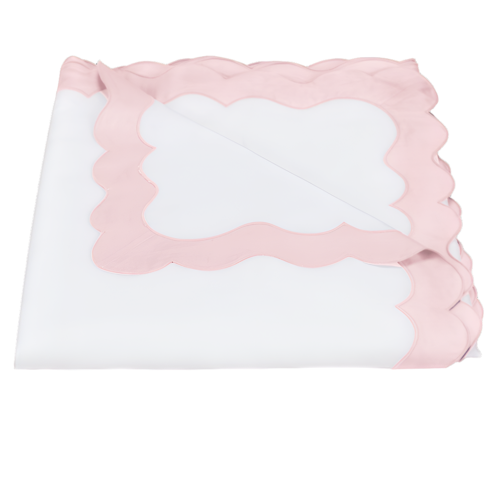 A folded white bedsheet with pink scalloped trim from the Lorelei Bedding Collection by Matouk, crafted in luxurious 600 thread count Milano Egyptian cotton, is displayed on a plain background.
