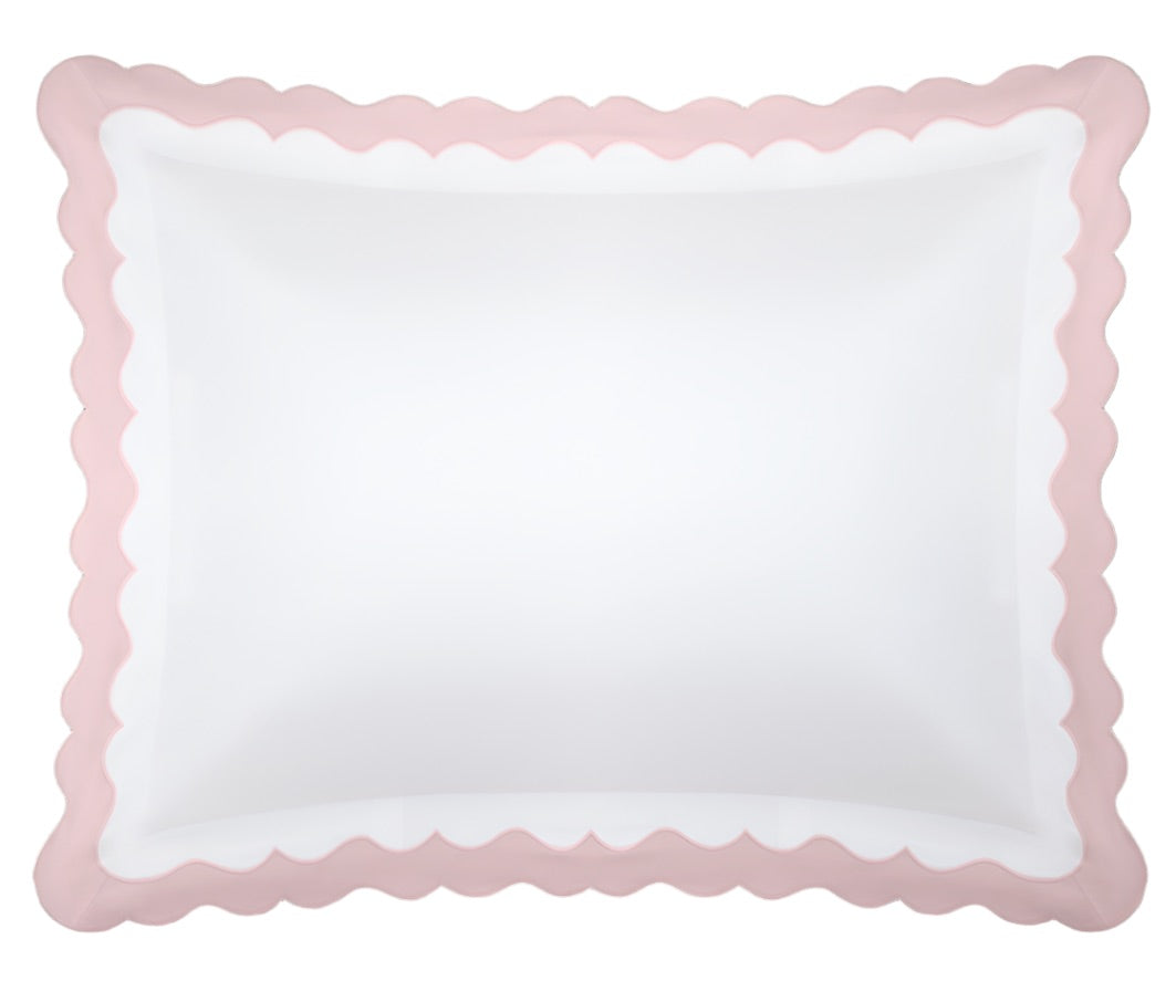 From the Lorelei Bedding Collection by Matouk, this white rectangular pillow features an elegant appliqué scallop in light pink along the border and is expertly crafted from luxurious 600 thread count Egyptian cotton. Presented from a top-down view against a plain background.