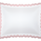 The Matouk Lorelei Bedding Collection, Pink, features a square white pillow with a pink scalloped border, crafted from Milano Egyptian cotton (600 thread count) and OEKO-TEX® certified, shown from above on a white background.