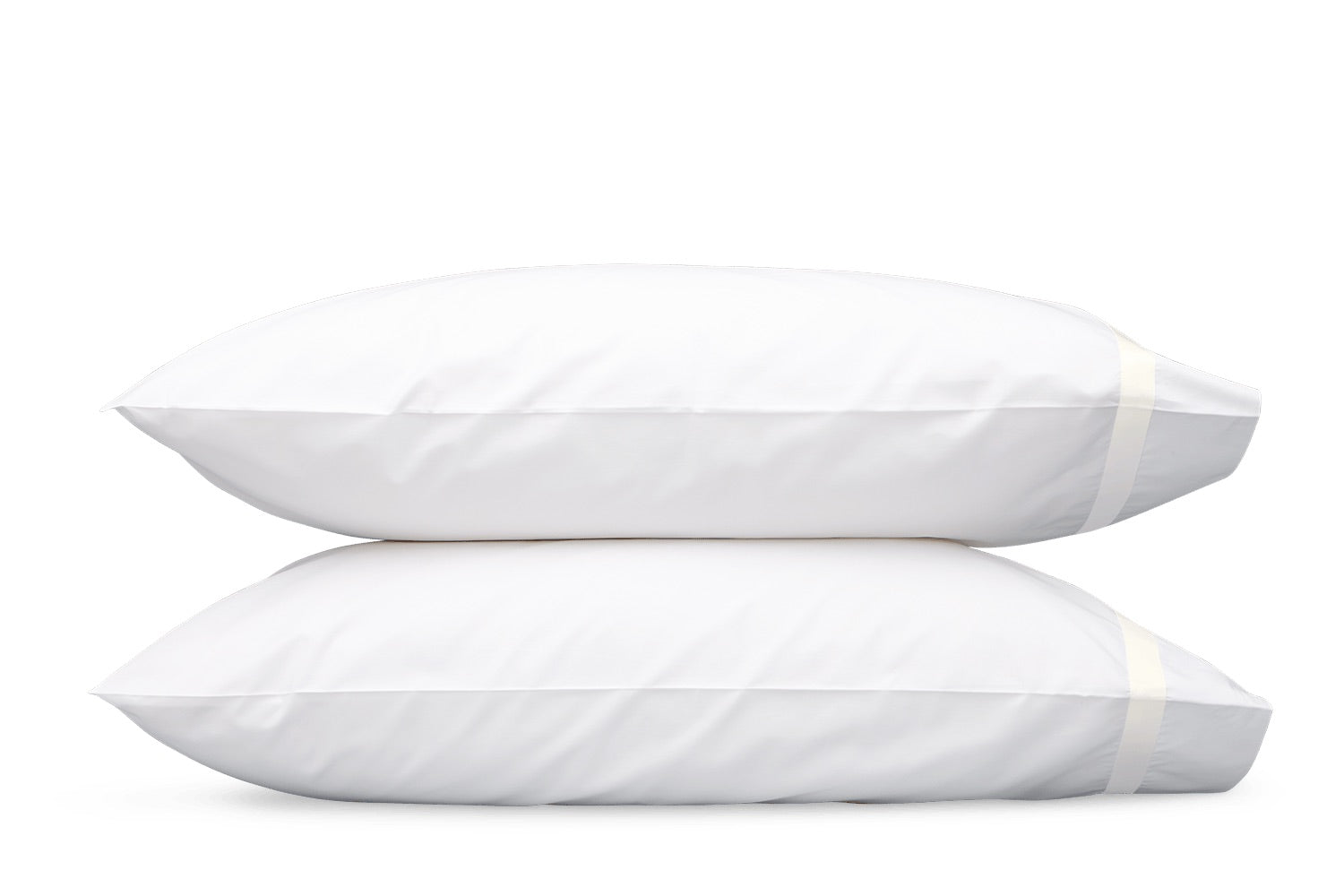 Two white pillows from the Matouk Lowell Bedding Collection, expertly crafted from luxurious Egyptian cotton percale with a smooth 600 thread count, are stacked atop one another against a plain white background—a perfect addition for elevating your luxury bedding ensemble.