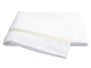 Two folded white bed sheets from the Lowell Bedding Collection by Matouk, featuring a subtle beige stripe near the edge. Expertly crafted from Egyptian cotton percale for exceptional softness and breathability, these luxurious sheets are displayed on a plain white background—perfect for elevating your home bedding experience.