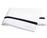 Two neatly folded pillowcases from the Matouk Lowell Bedding Collection, crafted from luxurious 600 thread count Egyptian cotton percale, feature a single horizontal black stripe near the edge and are displayed side by side on a plain white background.