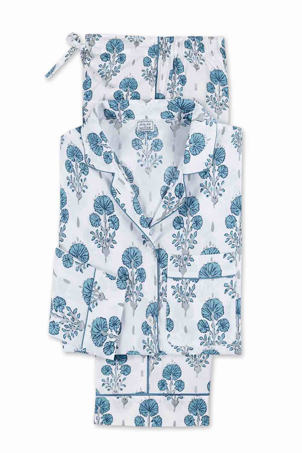 The Matouk Luca Pajama Set features a folded white cotton percale design with blue floral print, including a button-up collared top with front pocket and matching drawstring pants.