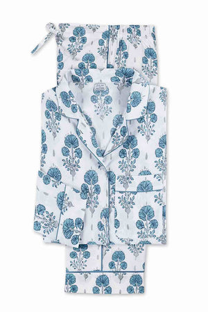 The Maotuk Luca Pajama Set by Matouk is a white cotton percale pajama set with blue floral patterns, featuring a button-up top and drawstring pants, folded neatly.