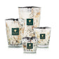 Four Baobab Collection Halona White World candles in various sizes with a speckled white, black, and amber pattern, each featuring a green square label with a tree logo and text.