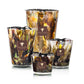 Four Baobab Collection Halona Yellow World Candle hand-blown glass vessels in varying sizes, featuring an abstract brown, yellow, and black swirled pattern with a square label on each.