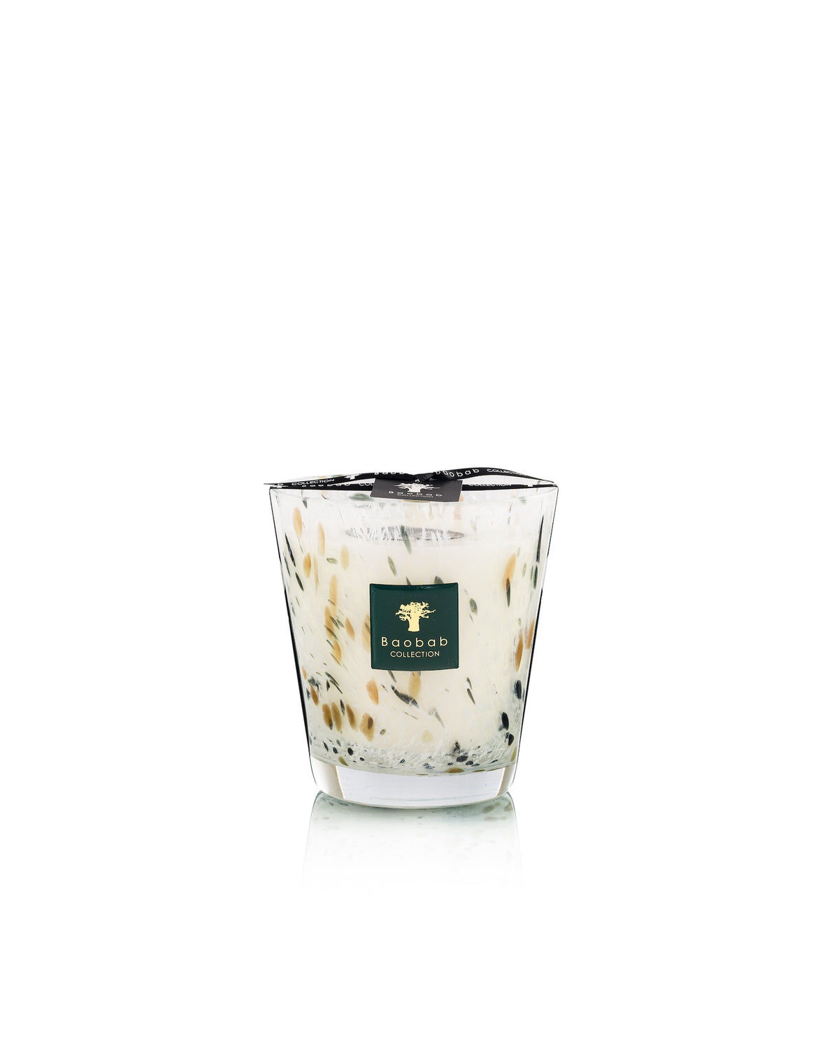 Baobab Collection Halona White World Candle in a hand-blown glass vessel filled with white wax and speckled with dark, leaf-like accents.
