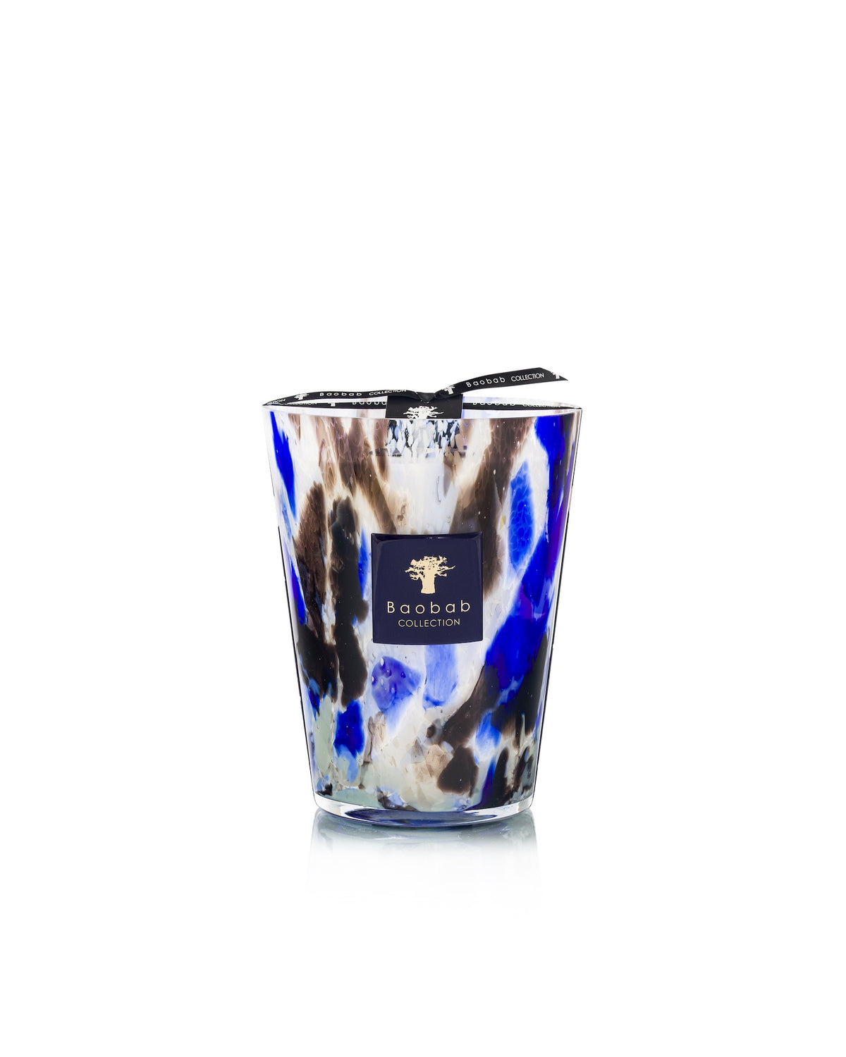 Baobab Collection Halona Blue World hand-blown glass candle featuring a blue, black, and white marbled pattern, a branded label, and a woody fragrance.