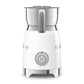 The SMEG Milk Frother Collection by Smeg is a white electric frother with a stainless steel carafe, featuring a start/stop button on the front and a side handle.