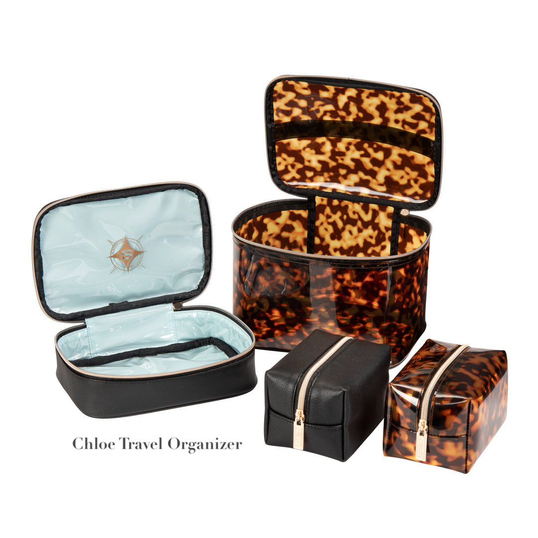 Four travel organizer bags from the Stephanie Johnson Miami Tortoise Travel Collection, featuring tortoiseshell and black designs with faux-leather trim and clear compartments. Bags shown open and closed. Text: "Chloe Travel Organizer.