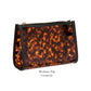 A medium-sized cosmetic bag from the Miami Tortoise Travel Collection by Stephanie Johnson, featuring a tortoiseshell pattern and faux-leather trim. Shown against a white background with "Medium Zip Cosmetic" below. Ideal for organizing travel essentials.
