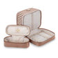 The Marbella Mocha Travel Collection by Stephanie Johnson features a beige and brown set with one rectangular travel case and a smaller cosmetic pouch, both open to reveal compartments and elastic straps inside.