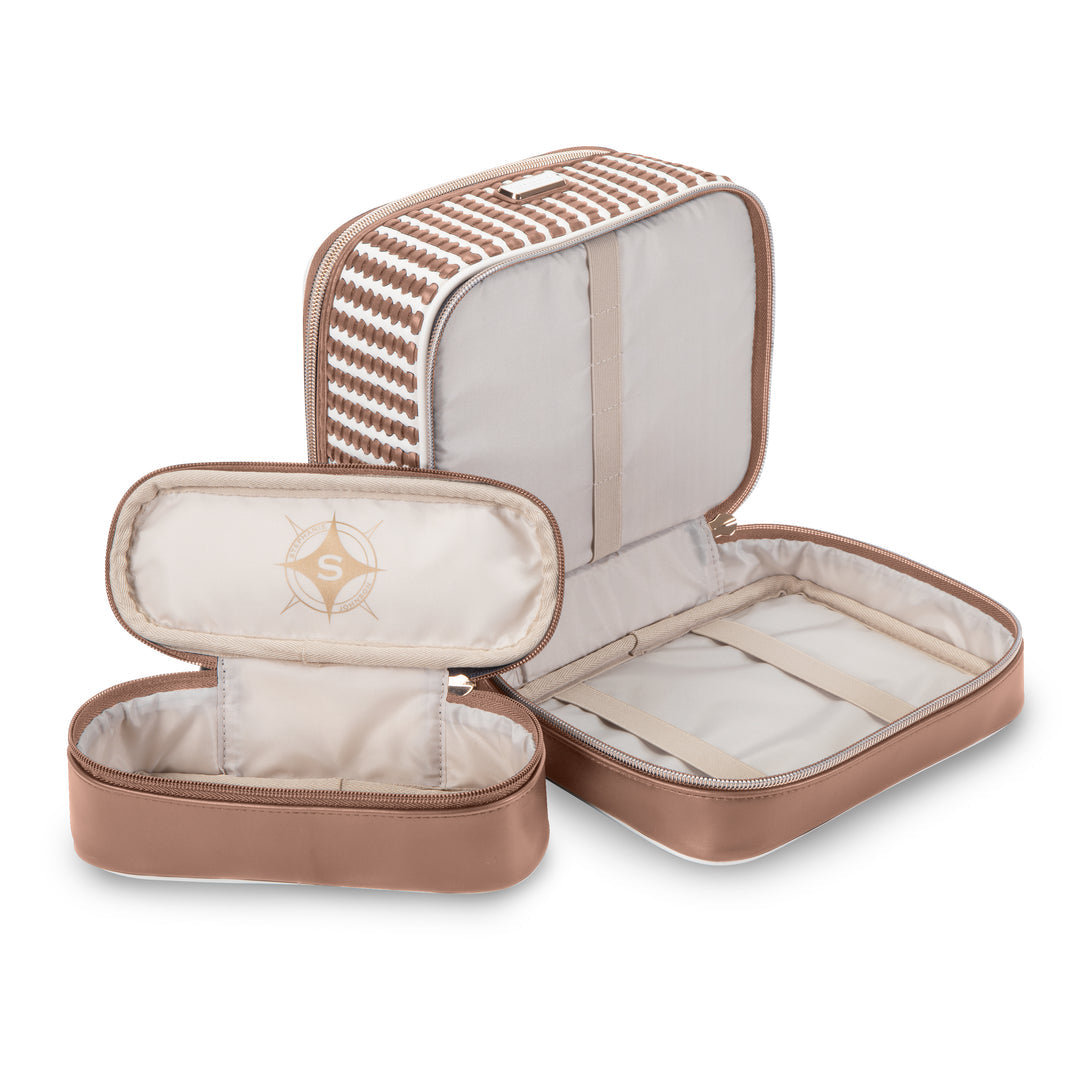 The Marbella Mocha Travel Collection by Stephanie Johnson features a beige and brown set with one rectangular travel case and a smaller cosmetic pouch, both open to reveal compartments and elastic straps inside.