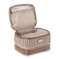 From the Marbella Mocha Travel Collection by Stephanie Johnson, this beige and brown travel case features a textured exterior. When open, it reveals a zippered mesh pocket in the lid and an inner removable cosmetic pouch with a stylish striped pattern.