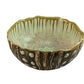 The Sea Urchin Bowl Collection by AE Ceramics features hand-molded ceramic bowls with wavy rims, green and brown glaze, vertical drips, and raised circular designs—perfect as unique tabletop accessories.