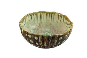 The Sea Urchin Bowl Collection by AE Ceramics features hand-molded ceramic bowls with wavy rims, green and brown glaze, vertical drips, and raised circular designs—perfect as unique tabletop accessories.