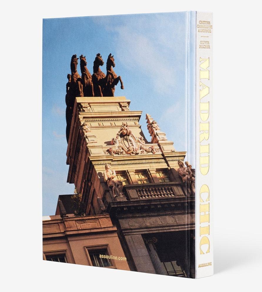 The cover image of Assouline's "Madrid Chic" captures the essence of Spanish life, featuring a building with statues and architectural details set against a vibrant blue sky.